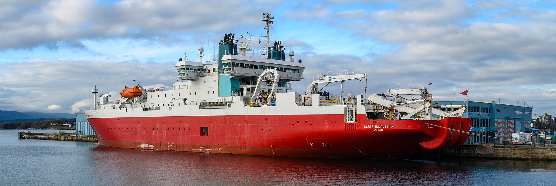 A cable-laying ship at sea deploying a thick undersea data cable